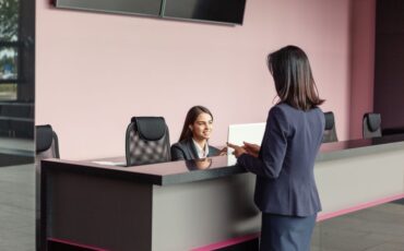 A receptionist in office is manually working on Visitor Management System